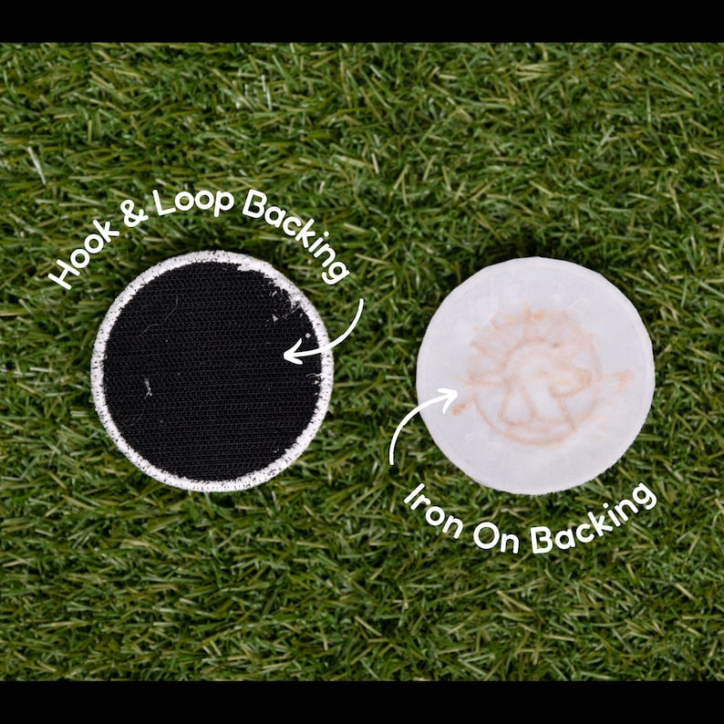 May include: Two round patches, one with a black hook and loop backing and the other with a white iron-on backing. The iron-on backing has a brown design of a dog.