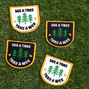 May include: Four embroidered iron-on patches with a yellow border. Each patch features a green tree design with the text "See a tree, take a wee" in black and white lettering.