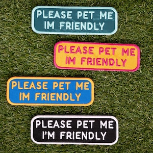 May include: Four colourful iron-on patches with the text "PLEASE PET ME I'M FRIENDLY" in different colours and fonts.