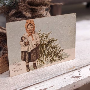 Postal navideña antigua de 1906: Niña y árbol