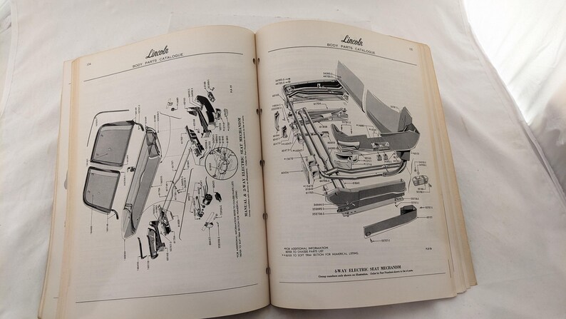 May include: A black and white exploded diagram of a car's rear window and seat mechanism. The diagram shows the parts and their corresponding numbers. The text "AWAY ELECTRIC SEAT MECHANISM" is visible at the bottom of the page.
