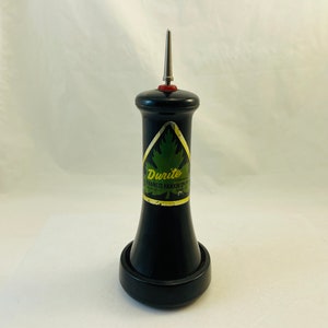 May include: Black and gold bottle with a pointed top and a label that reads "Durice Trade Mark Francis Hankin Co."
