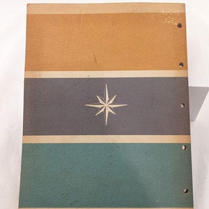 May include: A vintage three-ring binder with a brown, gray, and green striped cover. A white star is centered on the gray stripe.