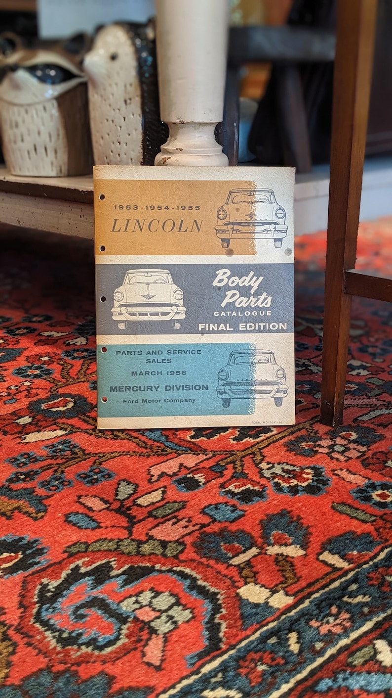 May include: A vintage 1953-1955 Lincoln and Mercury Body Parts Catalogue, final edition, from March 1956. The cover features a blue and white car illustration and the text "Body Parts Catalogue Final Edition".