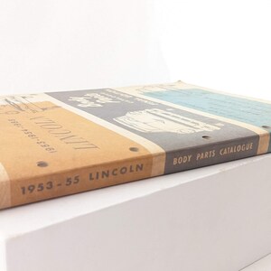 May include: A vintage 1953-55 Lincoln Body Parts Catalogue, March 1958, with a brown cover and the text "1953-55 Lincoln Body Parts Catalogue March 1958" printed on the spine.