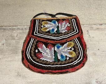 May include: A small, beaded bag with a flap closure. The bag is decorated with colorful floral patterns and has a brown leather strap.