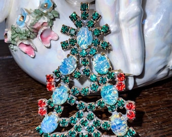 May include: A vintage Christmas tree brooch with green and red rhinestones and iridescent blue stones.