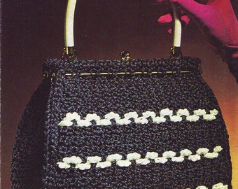 May include: A black and white crocheted handbag with a white handle. The bag has a 'Mayfair' crochet handbag label and the text 'by Atlas'.