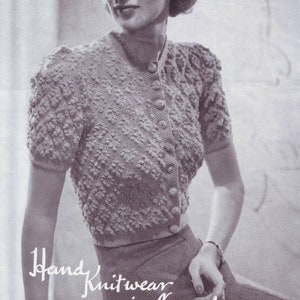May include: A black and white photo of a woman wearing a knitted cardigan with a button-up front. The cardigan has a textured pattern and short sleeves. The text "Hand Knitwear in Lavenda" is written below the woman. The text "No. 817 3d." is in the top right corner of the image.