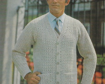 May include: A light beige, button-down cardigan sweater with a V-neck and two front pockets. The sweater has a textured, open-weave design. The person in the image is wearing a light blue shirt and a striped tie.