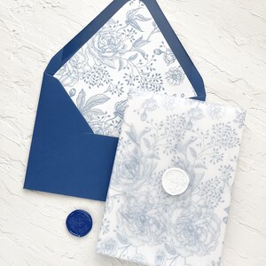 Puede incluir: Un sobre azul con un patr&oacute;n floral blanco en el interior. El sobre est&aacute; sellado con un sello de cera azul. Un sobre blanco con un patr&oacute;n floral azul est&aacute; dentro del sobre azul.