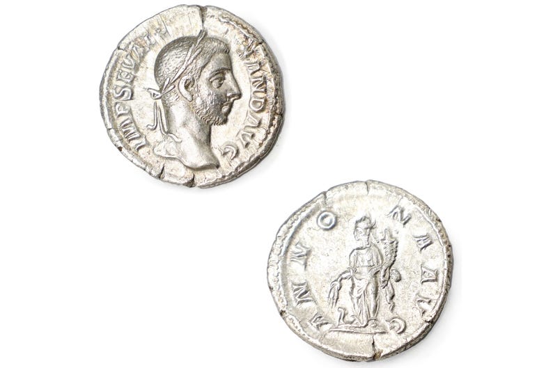 K&ouml;nnte beinhalten: Zwei r&ouml;mische Silberm&uuml;nzen. Eine M&uuml;nze zeigt das Profil eines Mannes mit Lorbeerkranz und Text am Rand. Die andere M&uuml;nze zeigt eine stehende Figur und Text. Beide M&uuml;nzen haben ein abgenutztes, antikes Aussehen.