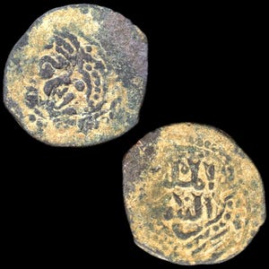 May include: Two antique bronze coins with intricate designs and inscriptions. The coins have a weathered appearance, with a mix of brown and green hues, suggesting age and historical significance. The background is black.