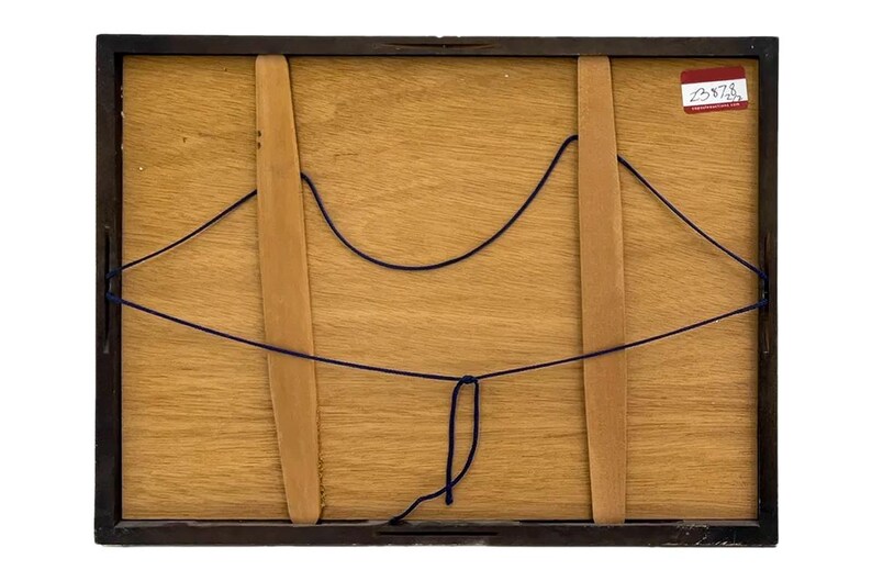 May include: Back of a framed artwork. The frame is dark brown, and the backing is light brown wood. Two wooden supports are visible, held in place with dark blue string. A small sticker with text is in the upper right corner.