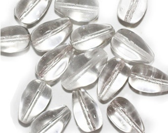 May include: A group of clear glass teardrop-shaped beads with a silver stripe running through the center of each bead.