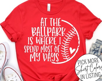 May include: Red t-shirt with a white baseball graphic and the text "At the ballpark is where I spend most of my days".