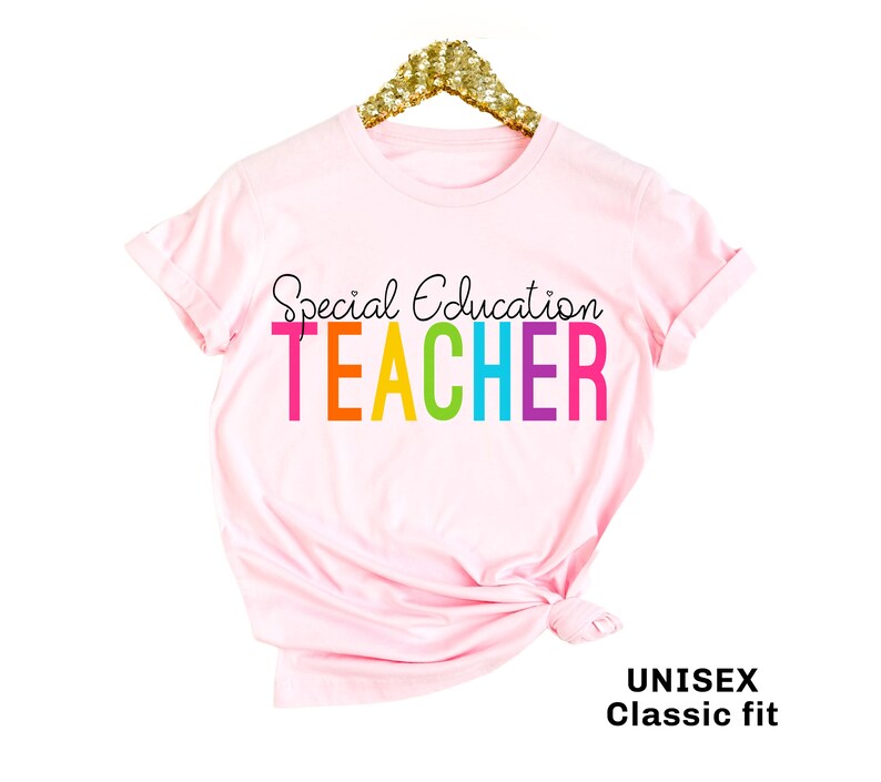 May include: Pink t-shirt with the text "Special Education Teacher" in rainbow colors. The shirt is a unisex classic fit.