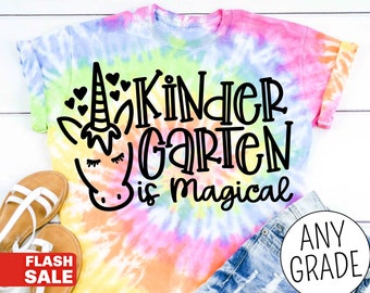 May include: Tie-dye t-shirt with a unicorn and the text "Kindergarten is magical".