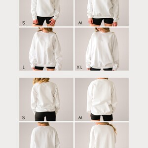 May include: A collection of plain white crewneck sweatshirts shown in sizes S, M, L, and XL. The images display both the front and back views of the long-sleeved pullover garments, each featuring ribbed cuffs and a ribbed hemline in a solid white colour.