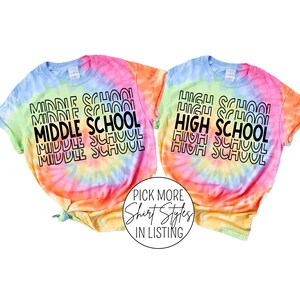 May include: Two tie-dye t-shirts with the text "MIDDLE SCHOOL" and "HIGH SCHOOL" in black text on a rainbow tie-dye background.