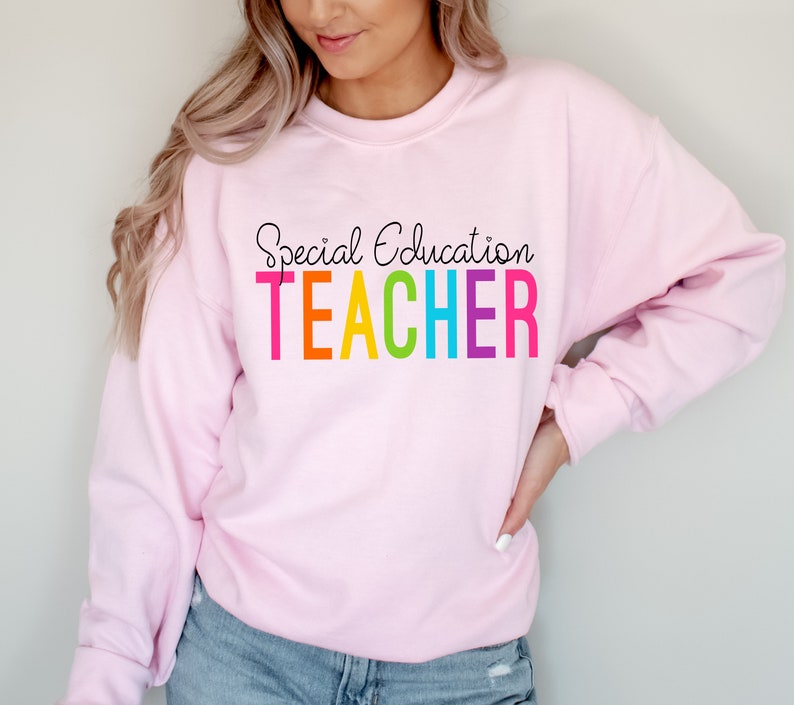 May include: Pink sweatshirt with the text "Special Education TEACHER" in rainbow colors.