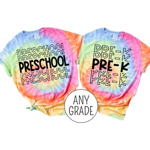 May include: Two tie-dye t-shirts with the text "PRESCHOOL" and "PRE-K" in black. The shirts are a rainbow of colors, including pink, orange, yellow, green, and blue.