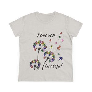 May include: A white ceramic mug with a black handle and the text "But First, Coffee" in a bold, black font. The mug is set against a neutral background, highlighting its simple design.