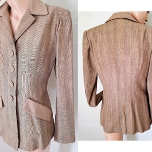 May include: A brown blazer with a satin collar and pockets. The blazer has a fitted silhouette and a button-up front.