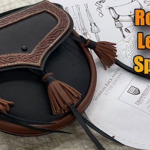 May include: A brown leather sporran with a black flap and three brown tassels. The sporran is labeled "Rob Roy Leather Sporran" and "Sporran Back and Flap 3-7 oz Leather".