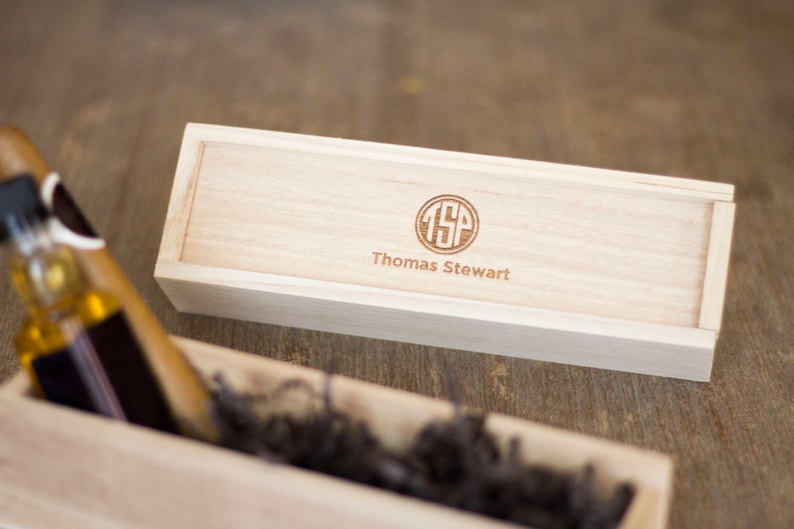 May include: A wooden box with a personalized engraved monogram "TSP" and the name "Thomas Stewart".
