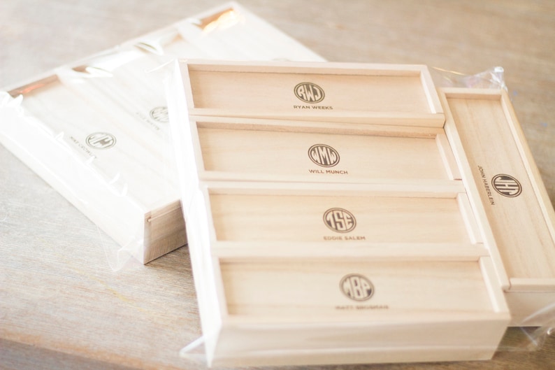 May include: A wooden box with five drawers, each with a different monogram and name. The names are Ryan Weeks, Will Munch, Eddie Salem, Matt Monroe, and John Harrelson.
