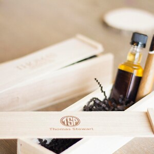May include: A wooden box with a lid, containing a small bottle of liquor and a cigar. The box is engraved with the initials "TSP" and the name "Thomas Stewart".