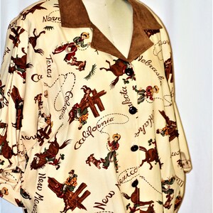 May include: A cream-colored jacket with a brown suede collar. The jacket is covered in a pattern of cowboys riding horses with the names of states written around them. The states include Texas, California, Nevada, Nebraska, Dakota, Colorado, New Mexico, and Arizona.