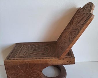 Afrikanischer Dogon-Hocker mit symbolischer Holzschnitzerei und abnehmbarer Rückenlehne.