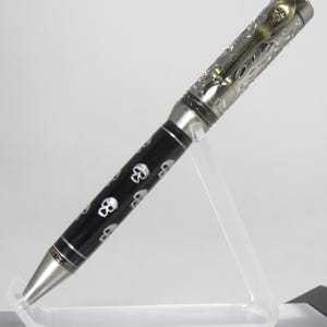 GHOST THEME: Ballpoint twist pen in clear acrylic resin over a black background with hand-painted, stylized silver skulls, my Item 201247