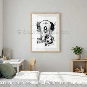 May include: Framed black and white print of a soccer jersey with the name "TONALI" and the number "8". The jersey is paired with a soccer ball and the text "THE MAGPIES". The artwork is displayed in a bedroom.