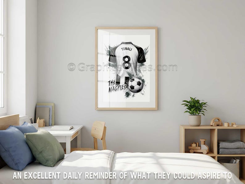 May include: Framed black and white print of a soccer jersey with the name "TONALI" and the number "8". The jersey is paired with a soccer ball and the text "THE MAGPIES". The artwork is displayed in a bedroom.