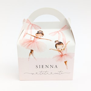 May include: A white cardboard gable box featuring a watercolor illustration of two ballerinas in pink tutus and ribbons. The text reads SIENNA is tutu cute in black lettering. The box has a handle at the top and a light pink scalloped base design.