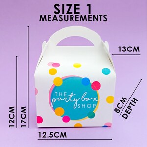 May include: White party favor box with a handle, adorned with colorful polka dots. The box features a teal circle with the text "The Party Box Shop." Measurements are 12 cm high, 17 cm to the handle, 12.5 cm wide, 8 cm deep, and 13 cm across.