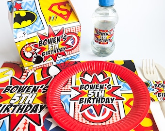 May include: A collection of superhero-themed party supplies. Includes a handled box, water bottle, red plate, placemat, and cutlery. All items feature a comic book style design with the text "Bowen's 5th Birthday".