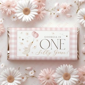 May include: Pink and white gingham chocolate bar wrapper with a white goose holding pink balloons. The text reads "Georgia is One Silly Goose!"