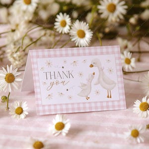 May include: A pink and white gingham thank you card with a watercolour illustration of two geese. The text "Thank you" is written in a cursive font.