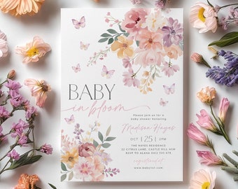 May include: A baby shower invitation with a floral design. The invitation reads "Baby in Bloom" and includes the date, time, and location of the event. It also includes the name of the guest of honor, Madison Hayes.