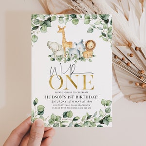 May include: A white invitation with green eucalyptus leaves and a gold "Wild One" text. The invitation features a watercolor illustration of a giraffe, elephant, lion, and zebra. The text reads "Please join us to celebrate Hudson's 1st Birthday! Saturday 15th May at 1pm 82 Forest Way, Palm Beach NSW Please RSVP to Jenna 0412 345 678"