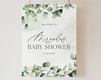 May include: A welcome sign for a baby shower with a watercolor background and greenery. The sign says "Welcome to Miranda's Baby Shower 12.05.2024".