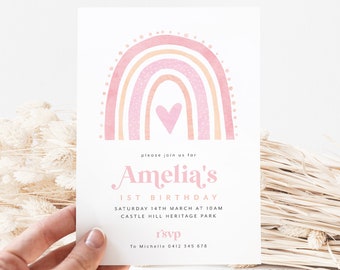 May include: A pink and orange watercolor rainbow with a pink heart in the center. The text "please join us for Amelia's 1st Birthday" is below the rainbow. The text "Saturday 14th March at 10am Castle Hill Heritage Park" is below the birthday text. The text "r'svp To Michelle 0412 345 678" is at the bottom of the invitation.