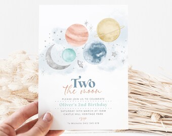 May include: A blue and white invitation card with a watercolor illustration of planets and stars. The text reads "Two the moon" and includes details for Oliver's 2nd birthday party.