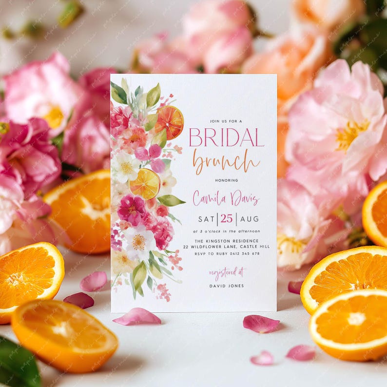 May include: A bridal brunch invitation with floral and citrus elements. The invitation includes the text "BRIDAL brunch" and details for Camila Davis's event on August 25th. Sliced oranges and pink flowers surround the invitation.