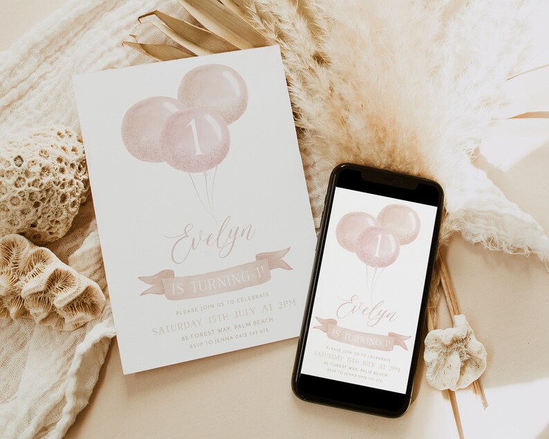 May include: A birthday invitation featuring three pink balloons, one with the number 1. The invitation reads "Evelyn is turning 1!" in elegant script, with additional details below. A smartphone displays the same design.