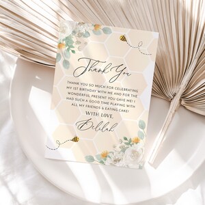 May include: A yellow and white thank you card with a honeycomb pattern and a bee illustration. The text on the card reads "Thank You" and "With Love, Delilah".